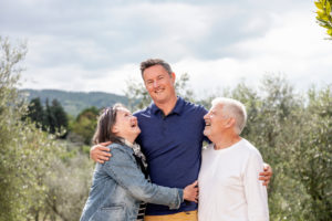 Senior couple with son, olive trees in background, Florence, Italy Senior couple with son, olive trees in background, Florence, Italy